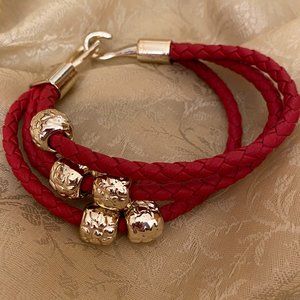 Red rope bracelet with gold accents